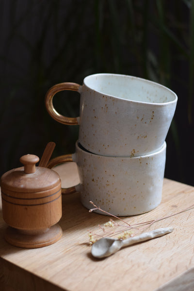 Organic white cylinder mug w/ gold handle